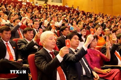 Các đại biểu biểu quyết thông qua nội dung Dự thảo Nghị quyết của Đại hội. (Ảnh: Đình Quân/TTXVN)