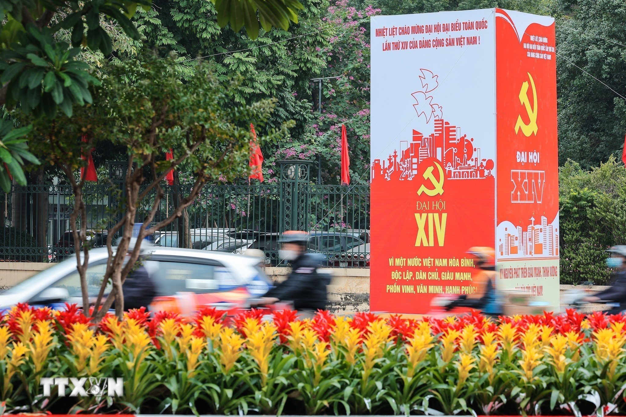 Khẩu hiệu, biểu trưng Đại hội nổi bật giữa dòng xe qua lại trên đường phố Hà Nội. (Ảnh: Lê Đông/TTXVN)