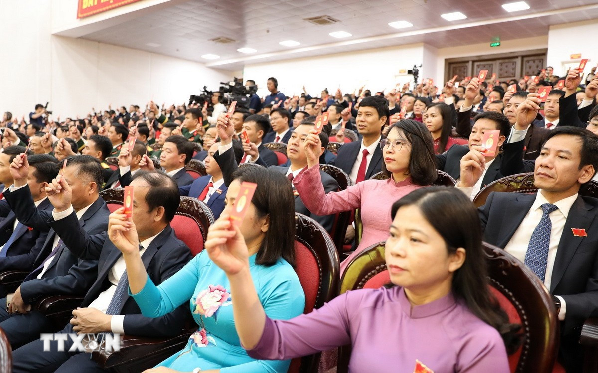 Các đại biểu biểu quyết thông qua dự thảo Nghị quyết Đại hội. (Ảnh: Đức Phương/TTXVN)