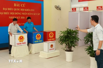 Các thành viên tổ bầu cử đang tiến hành việc thiết lập, bố trí khu vực bỏ phiếu ở phường Bàn Cờ, Thành phố Hồ Chí Minh. (Ảnh: Hữu Duyên/TTXVN)