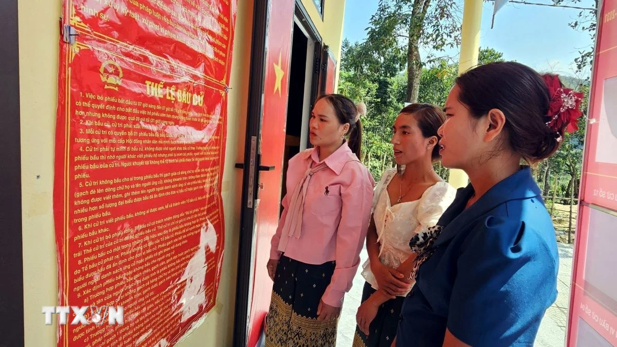 Đồng bào Bru-Vân Kiều (xã Trường Sơn, Quảng Trị) đọc các quy định về công tác bầu cử. (Ảnh: TTXVN phát)