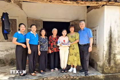 Tiến sỹ Phan Bích Thiện (thứ 2 từ phải sang), Chủ tịch Diễn đàn phụ nữ Việt Nam tại châu Âu, thăm gia đình con đỡ đầu tại Việt Nam. (Ảnh: TTXVN phát)